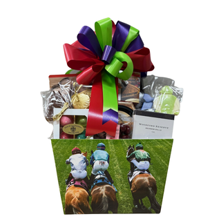 Gift basket with a colorful bow, including chocolate and other items, on a white background.